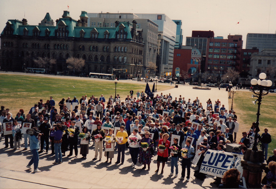 Delegates from CUPE National Health and Safety Conference in Ottawa attend a rally was at Parliament Buildings in support of the Day Of Mourning. The people in front with flowers represent all the provinces and territories, ca. 1988. Courtesy of Ed Thomas.