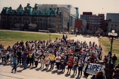 Delegates from CUPE National Health and Safety Conference in Ottawa attend a rally was at Parliament Buildings in support of the Day Of Mourning. The people in front with flowers represent all the provinces and territories, ca. 1988. Courtesy of Ed Thomas.